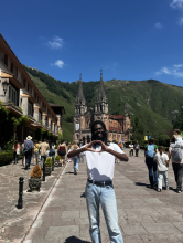 Jayden throws his "O" with a castle and a street of people in the background