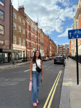 Girl standing in the middle of the street in London. 