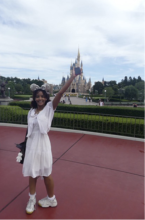 Sara stands in front of the Tokyo Disneyland castle