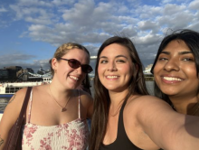 Nathalie and two other program participants with the river behind them and a cloudy sky above