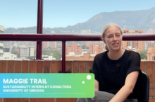 Maggie Trail sitting on a chair with the city and hill of Medellin, Columbia in the background