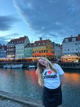 Frances smiling in Denmark wearing an "I Heart Copenhagen" shirt. 
