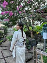 Evelyn smiling in a garden wearing traditional Japanese robes