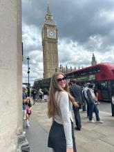 Jordan smiling with sunglasses near the Big Ben in London on a cloudy day