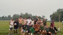 Cohort of GEO students playing soccer with locals on a foggy day in Nepal