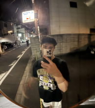 A uo student taking a mirror selfie on the street in Japan