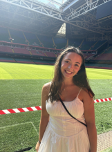 A uo student standing in front of a soccer field