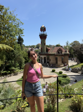 A uo student standing in some gardens
