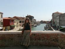 A uo student standing on a bridge over a canal in Milan