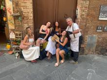 A group of uo student with a local shop owner in Siena