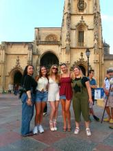 A group of UO students standing in a plaza