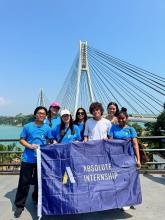 Group of Students holding a blue flag