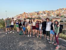 Group of UO students standing with a cityscape in the background