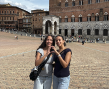 Two Students standing in a plaza