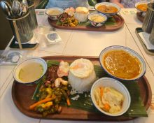 Two trays of food sitting on a white table