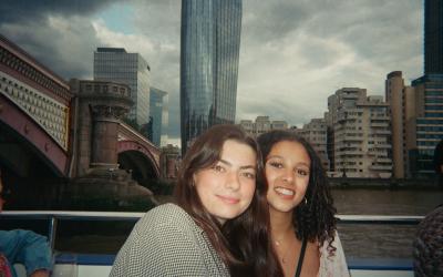 Two young women enjoying a cruise on the Thames River