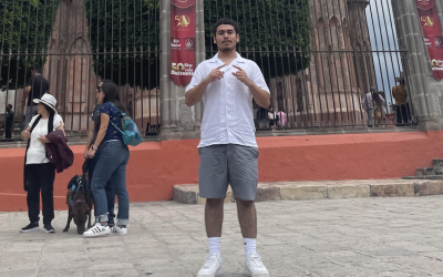 College male posing in front of a cathedral. 