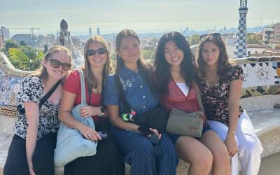 Five college students sitting on a bench in Copenhagen, Denmark. 