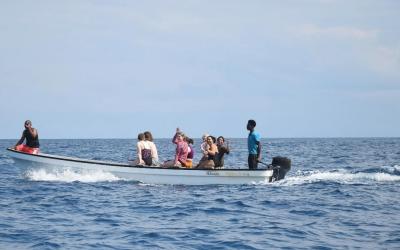 A group of people in a boat in the water