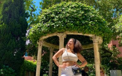 College-aged girl posing in front of a sitting area in Siena, Italy. 