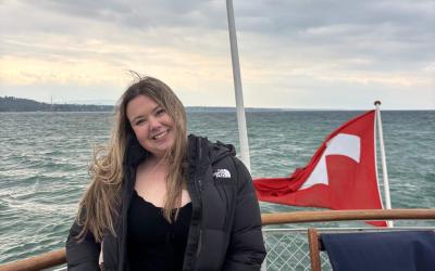 Person smiling on a boat with the Turkish flag visible in the background.