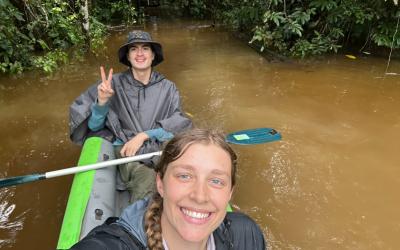 Two people kayaking in a river in Ecuador.