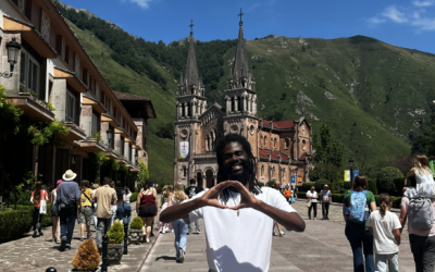 Jayden throws his "O" with a castle and a street of people in the background