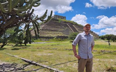 Alex standing in front of a large pyramid outside