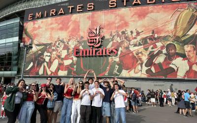 Group of people standing in front of Emirates Stadium