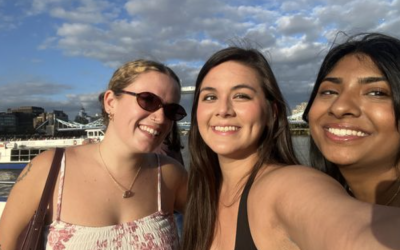 Nathalie and two other program participants with the river behind them and a cloudy sky above