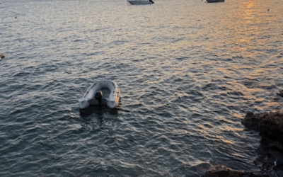 overlook of the water, scattered with boats, at sunset