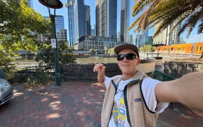 Calvin taking a selfie in sunny Melbourne with skyscrapers in the background.