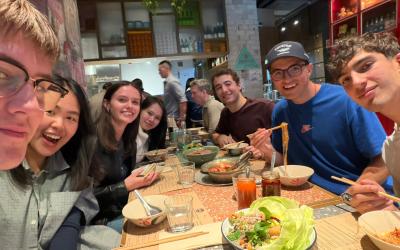 Group of students sitting at a dinner table