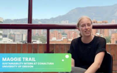 Maggie Trail sitting on a chair with the city and hill of Medellin, Columbia in the background