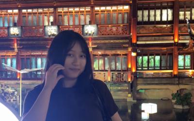 a uo student posing in front of Chinese temple 