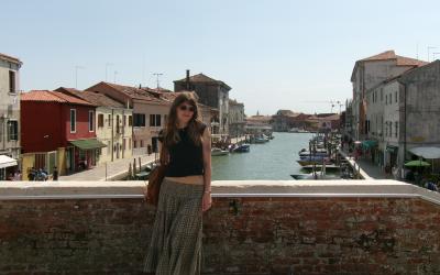 A uo student standing on a bridge over a canal in Milan