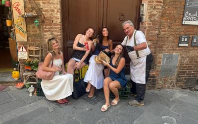 A group of uo student with a local shop owner in Siena