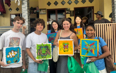 Six students holding paintings