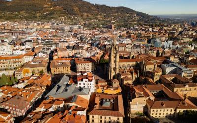Epic Spanish gothic city panorama. Cinematic aerial view of San Salvador Cathedral and orange roofs in Oviedo, Asturias, Spain