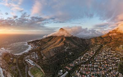 Sunset ocean, mountains, and city