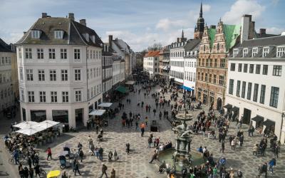 Overhead view of city square with fountain and buildings around it